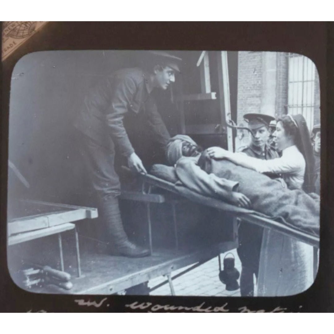 Original Glass slide showing a wounded Sikh soldier taken to an ambulance on a stretcher by an English nurse. WWI c1914 - ramblingsofasikh