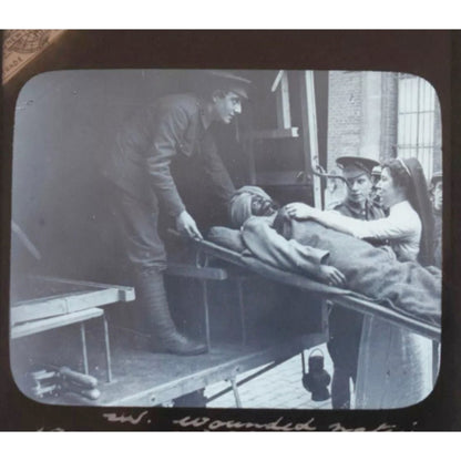 Original Glass slide showing a wounded Sikh soldier taken to an ambulance on a stretcher by an English nurse. WWI c1914 - ramblingsofasikh